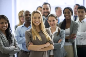 Group of people with folded arms smiling.
